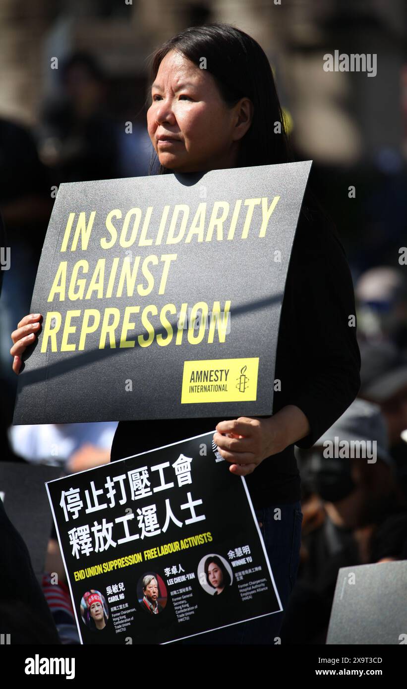 June 2, 2024, London, England, UK: A protester holds a sign saying ''˜In Solidarity Against Repression' during the demonstration in Parliament Square. The event commemorated the1989 student-led protests and the Chinese government's bloody crackdown on 4 June, as well as protest against China's current clampdown on freedom of speech - including its increasing repression of Tibetans and Uyghurs, its crushing of dissent in Hong Kong, and the intimidation of Chinese and Hong Kong students in the UK, Europe and North America. Thirty-five years on, the Chinese authorities still ban information rel Stock Photo