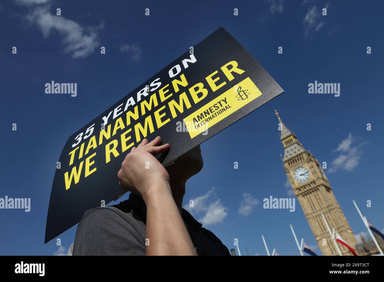 June 2, 2024, London, England, UK: A protester holds a sign saying ''˜35 Years On Tiananmen We Remember' during the demonstration in Parliament Square. The event commemorated the1989 student-led protests and the Chinese government's bloody crackdown on 4 June, as well as protest against China's current clampdown on freedom of speech - including its increasing repression of Tibetans and Uyghurs, its crushing of dissent in Hong Kong, and the intimidation of Chinese and Hong Kong students in the UK, Europe and North America. Thirty-five years on, the Chinese authorities still ban information re Stock Photo