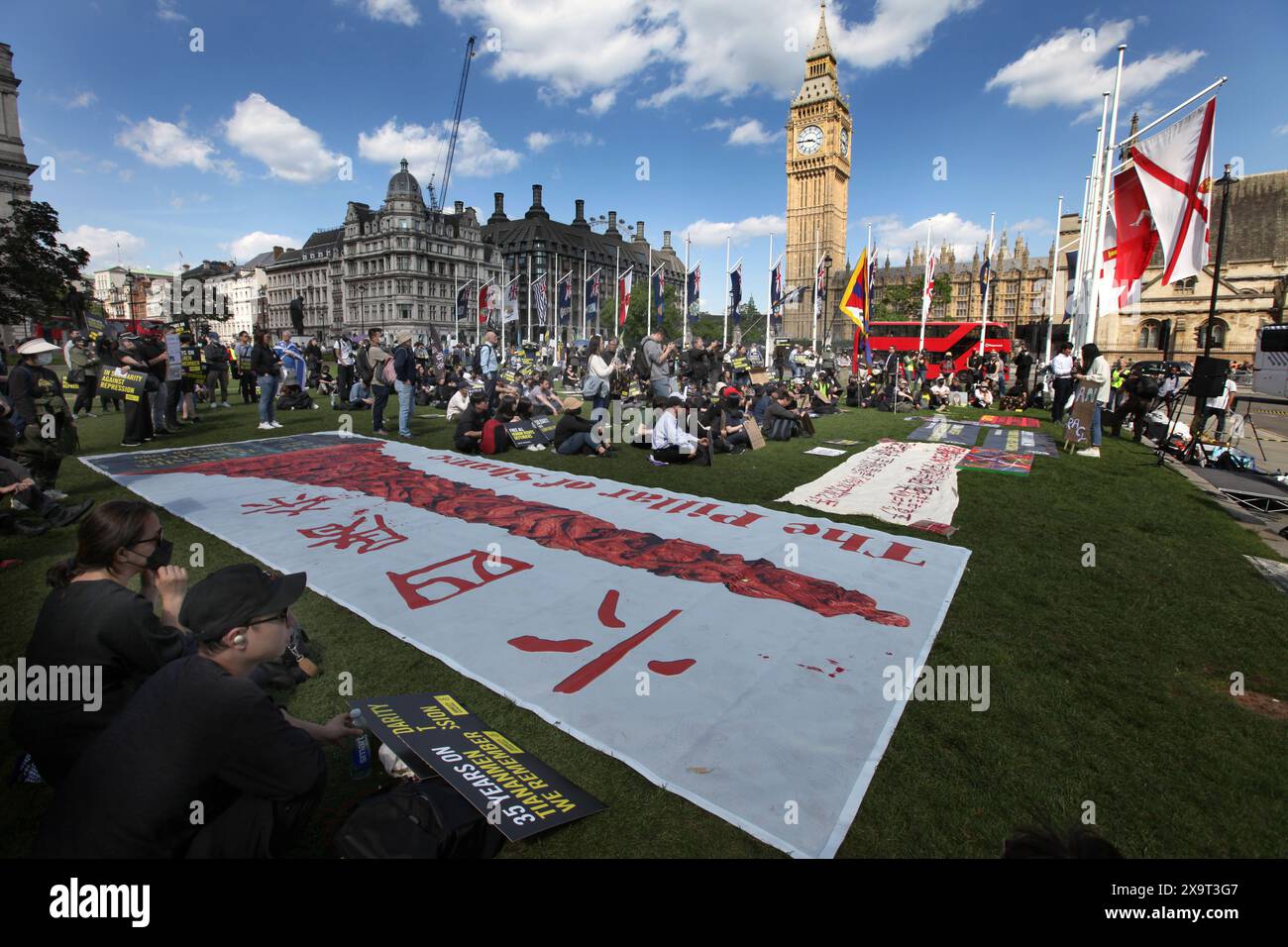June 2, 2024, London, England, UK: Protesters gather in Parliament Square alongside a large banner saying ''˜the Pillar Of Shame' during the demonstration. The event commemorated the1989 student-led protests and the Chinese government's bloody crackdown on 4 June, as well as protest against China's current clampdown on freedom of speech - including its increasing repression of Tibetans and Uyghurs, its crushing of dissent in Hong Kong, and the intimidation of Chinese and Hong Kong students in the UK, Europe and North America. Thirty-five years on, the Chinese authorities still ban informatio Stock Photo