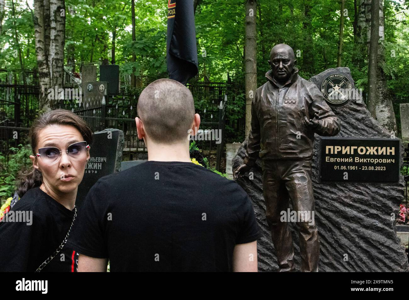 Couple stand near a sculpture of Russian mercenary leader Yevgeny ...