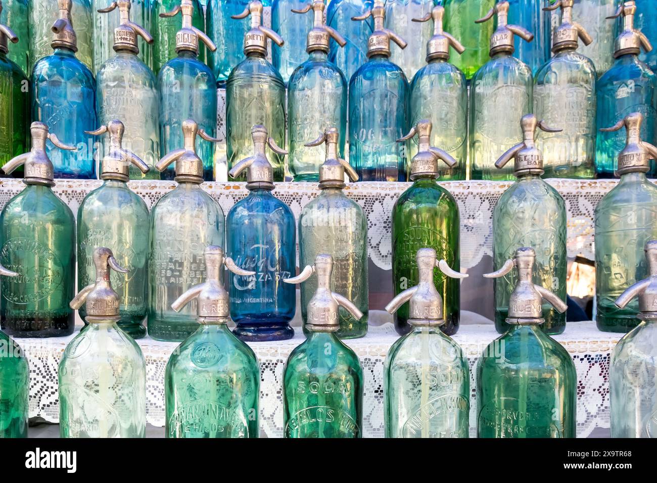 Retro colored soda water bottles for sale at the San Telmo’s outdoors Sunday flea market in Buenos Aires. Stock Photo