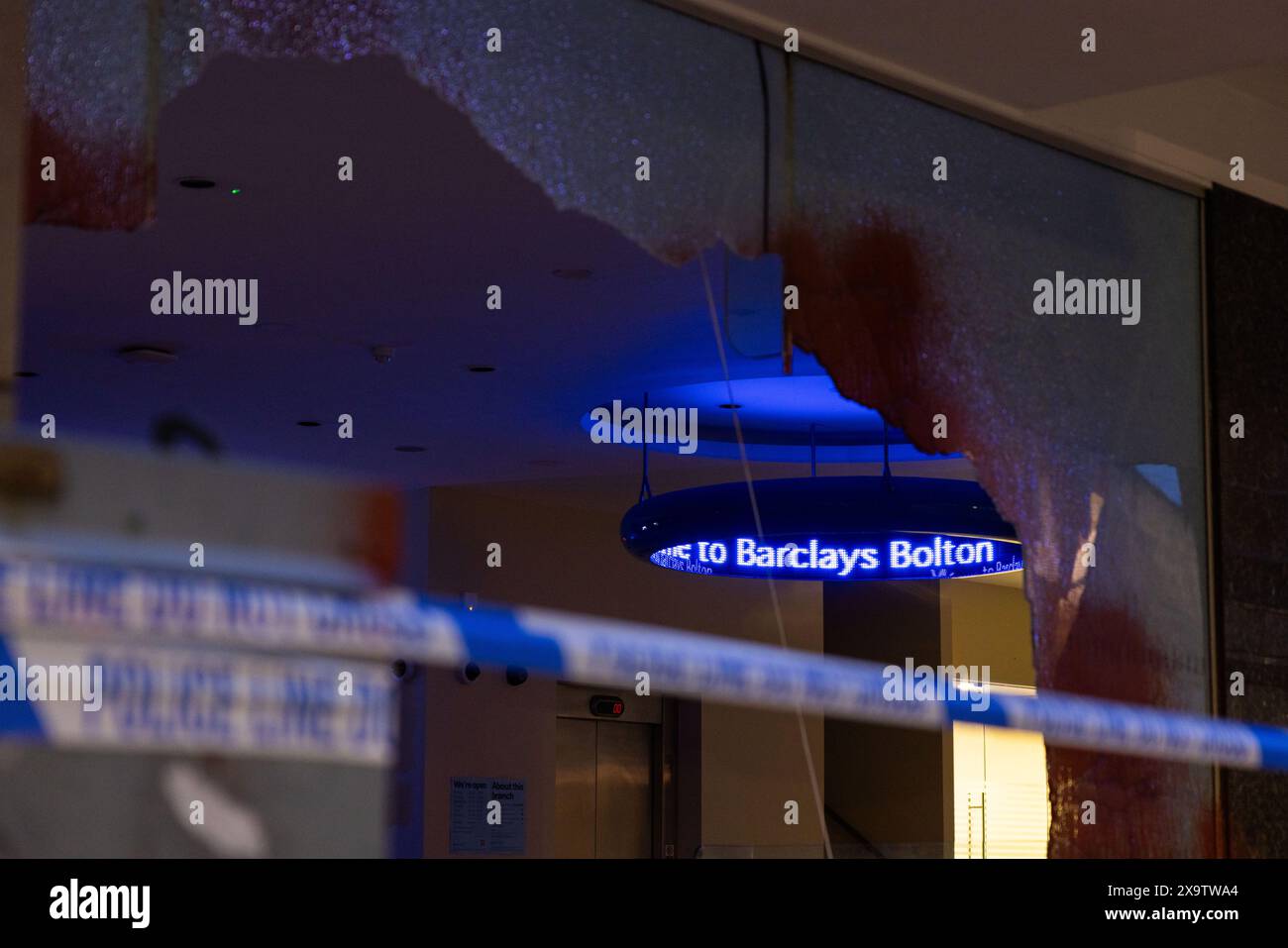 Bolton, UK. 03 JUN, 2024. LED sign behind police cordon as radical direct action group target Barclays Bank on Market St, Bolton by smashing 5 glass windows and walls and causing additional damage to the building with paint. Credit Milo Chandler/Alamy Live News Stock Photo