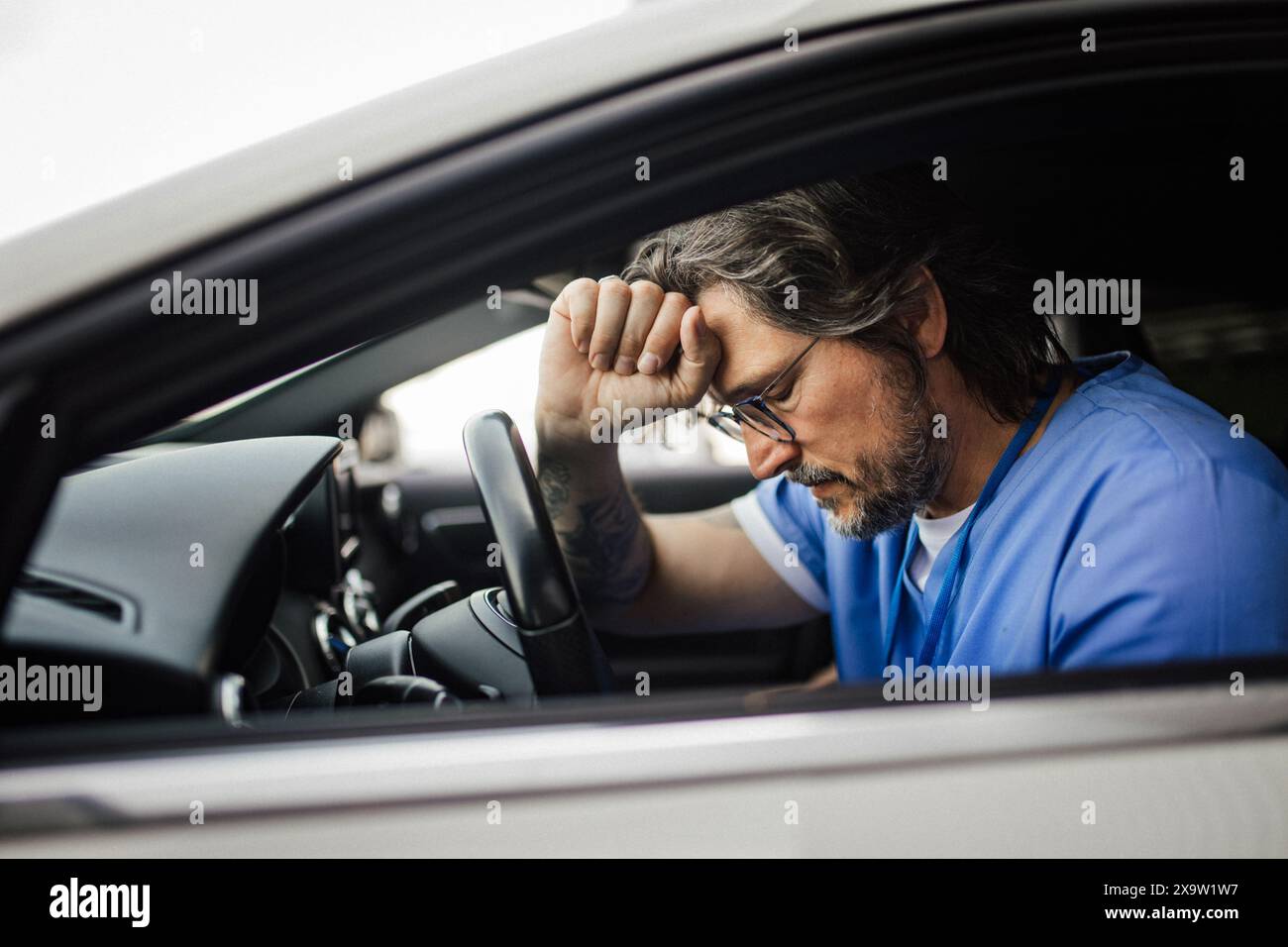 Sad man driving car crying hi-res stock photography and images - Alamy