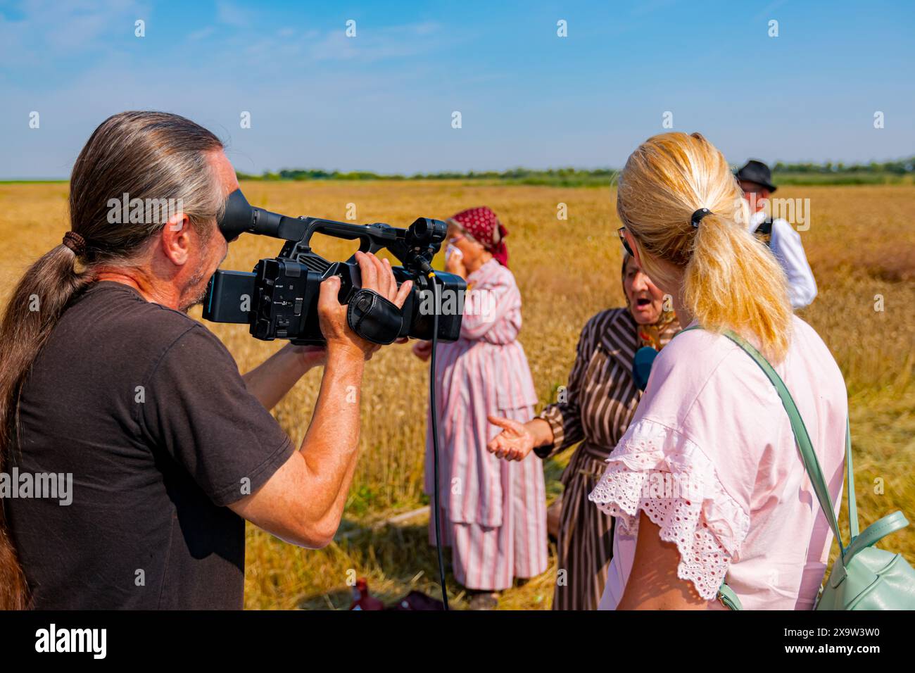Professional videographer filming interview hi-res stock photography ...