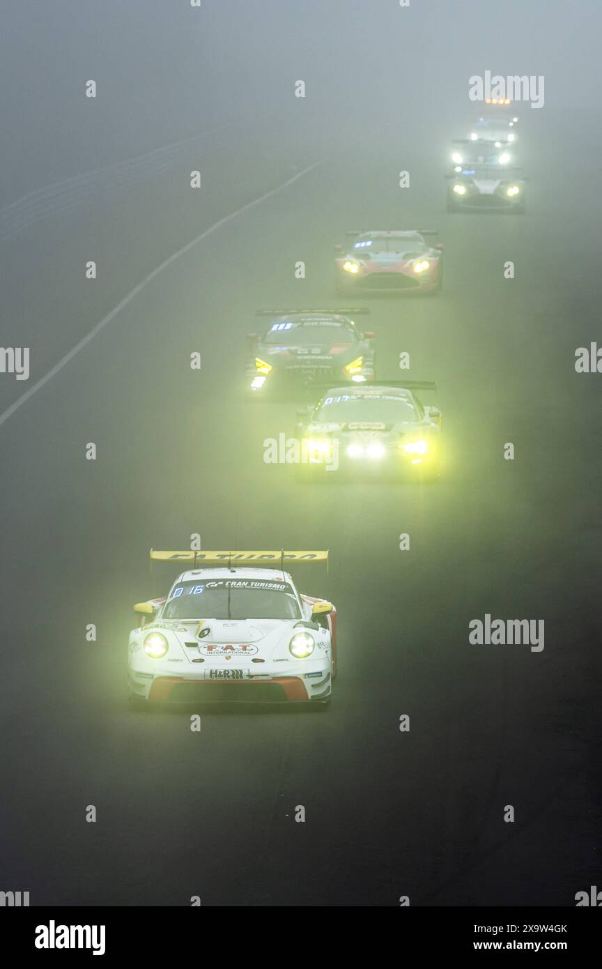 02 June 2024, Rhineland-Palatinate, Nrburg: Racing Cars Drive Through