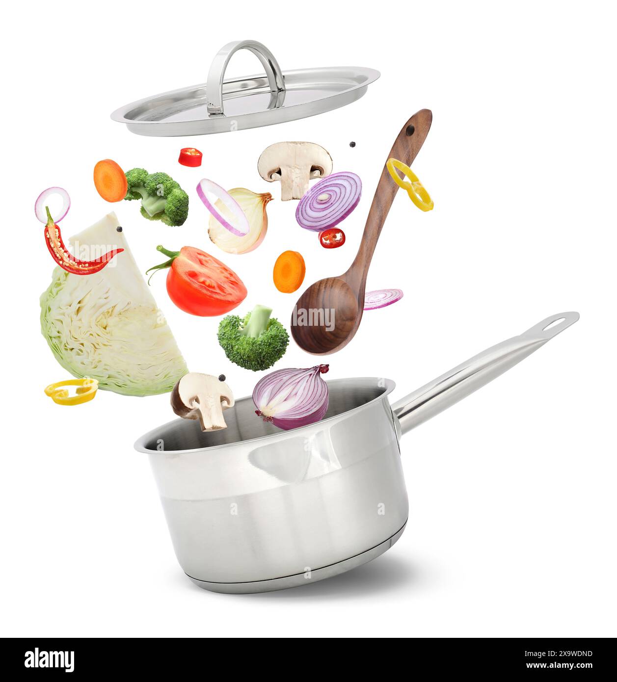 Fresh ingredients falling into saucepan on white background Stock Photo