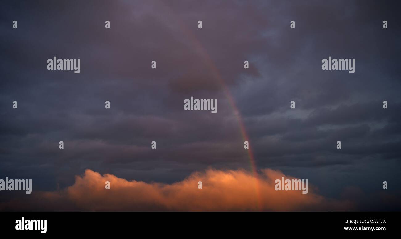 Rainbow in clouds hi-res stock photography and images - Alamy