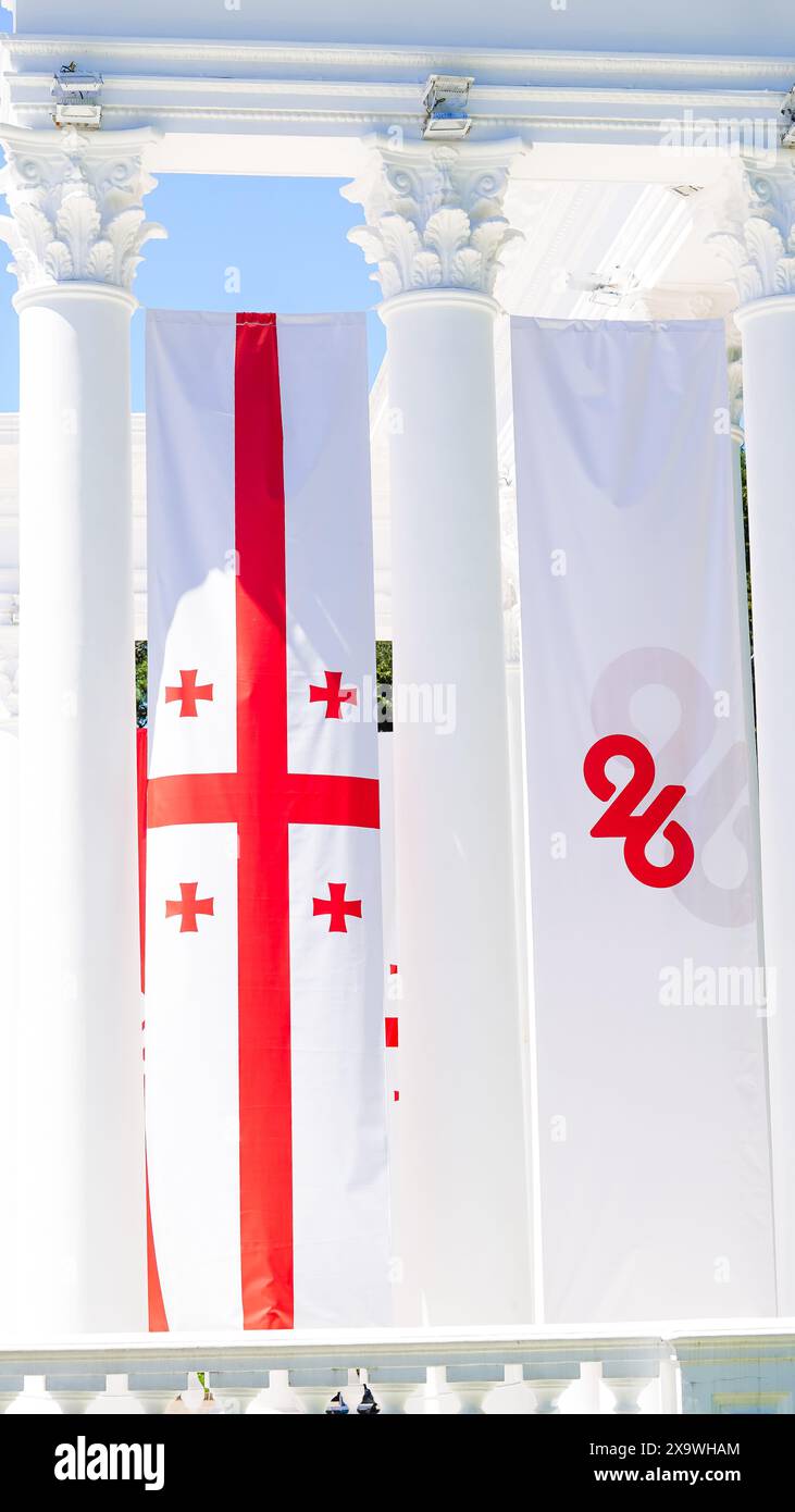 The flag of Georgia waves proudly in the park, symbolizing unity and ...