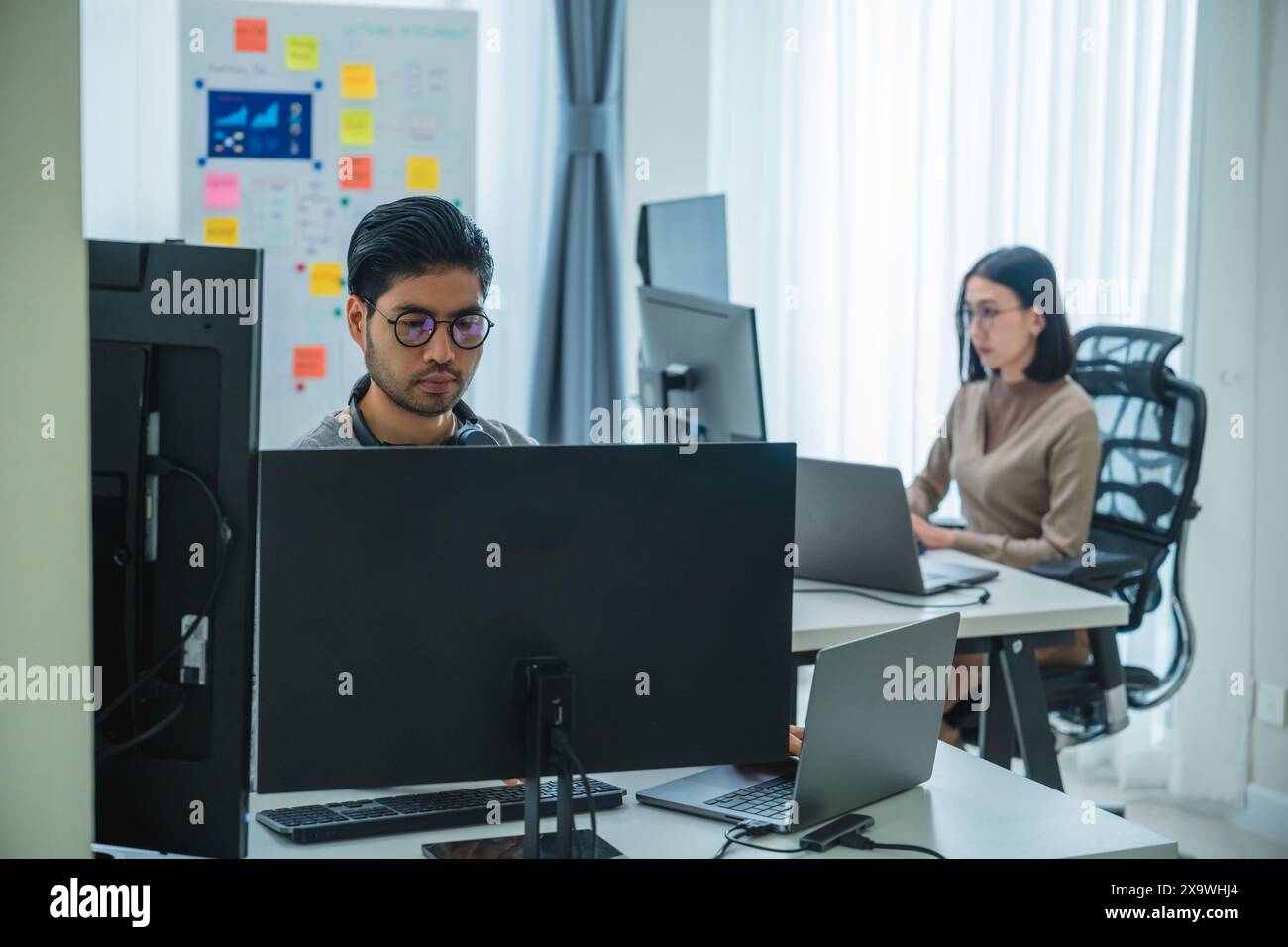 asian woman  and Indian man Developer team working  about programming software data online at office Stock Photo