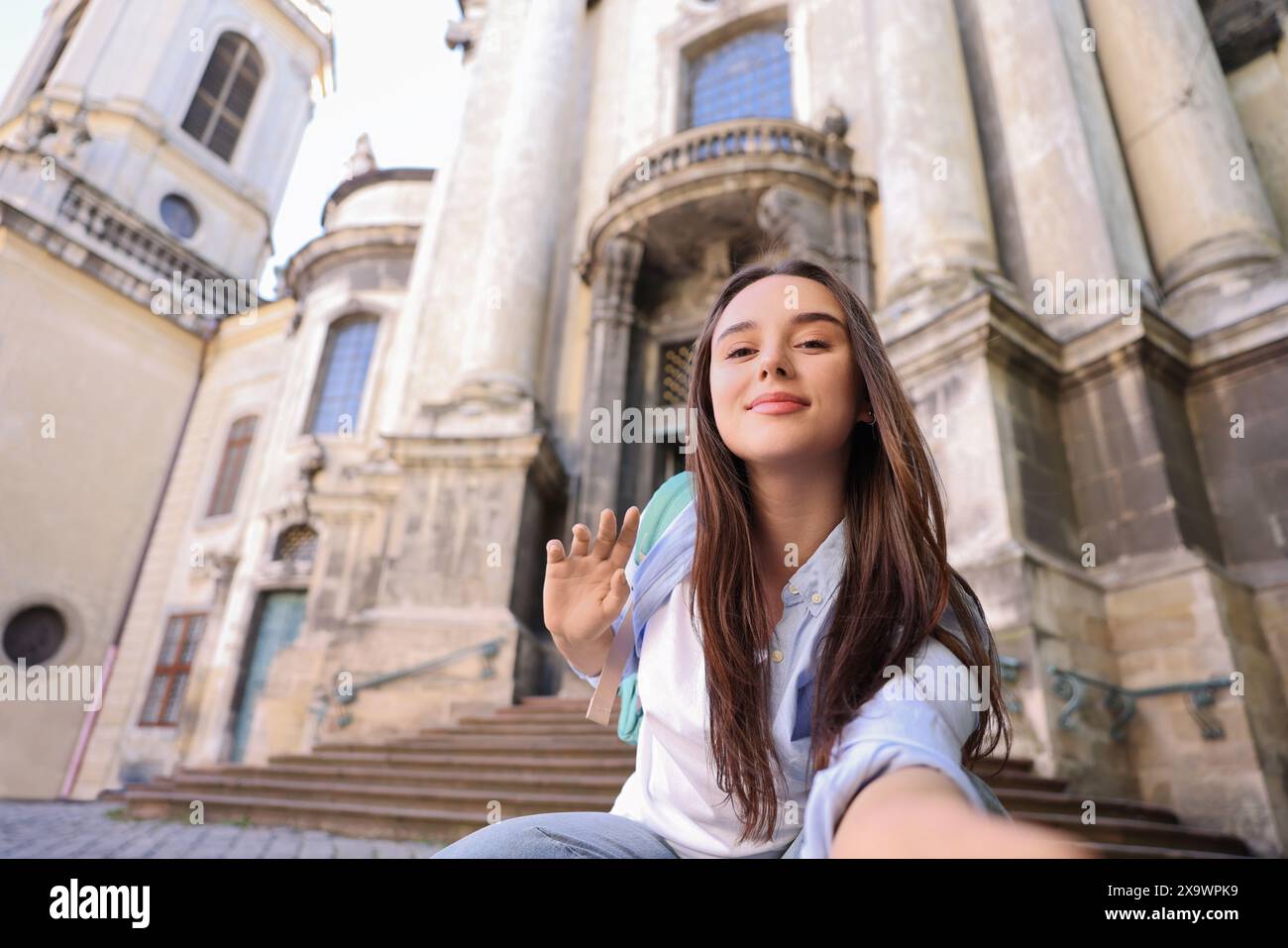 Beautiful travel blogger streaming outdoors, low angle view Stock Photo