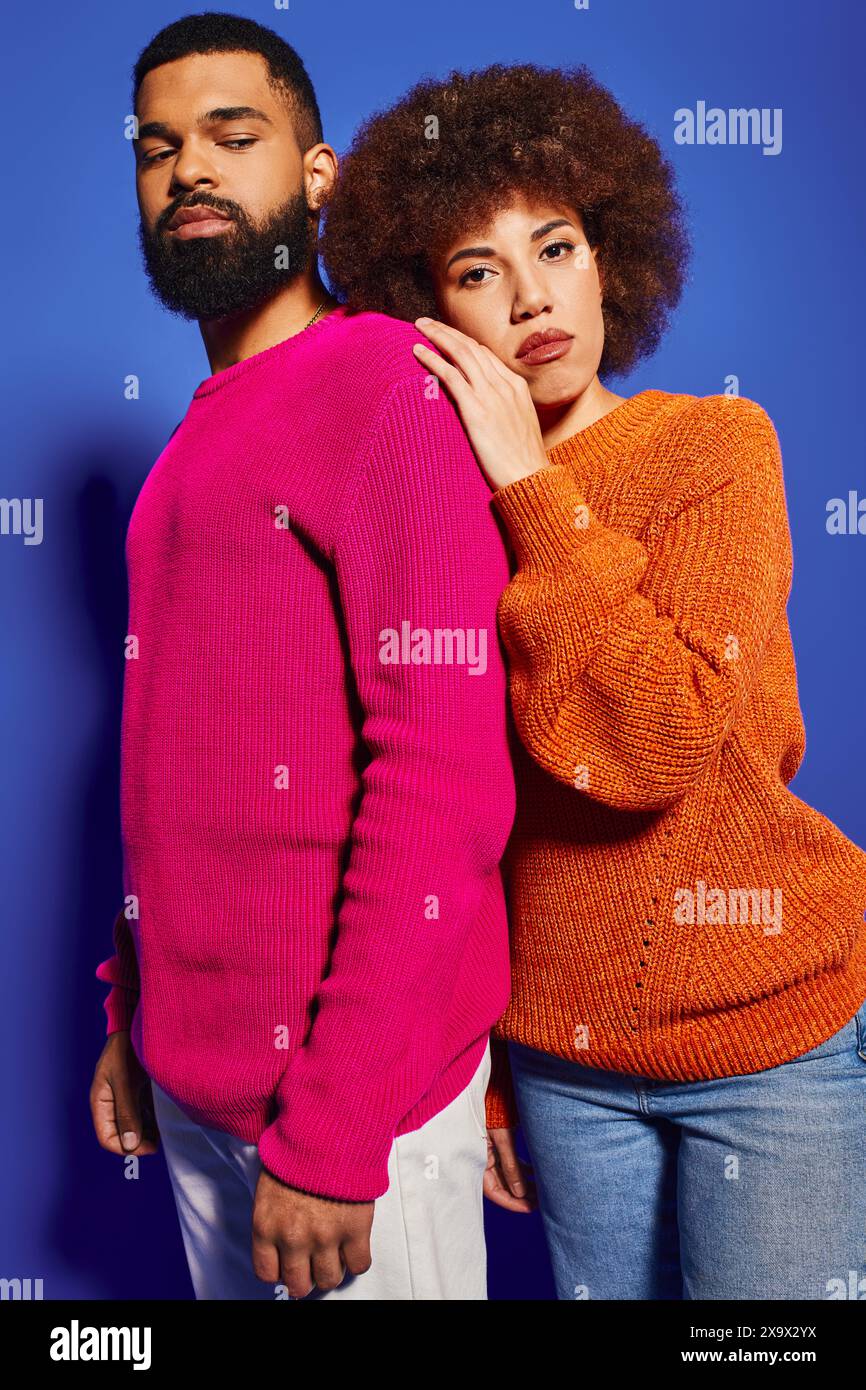 Young man and woman, friends, standing together in vibrant casual ...