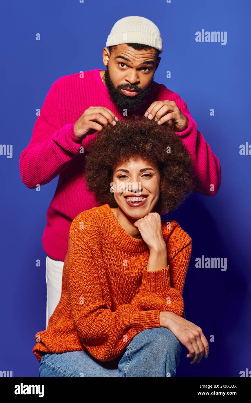 A young African American man and woman sit together, showcasing vibrant ...