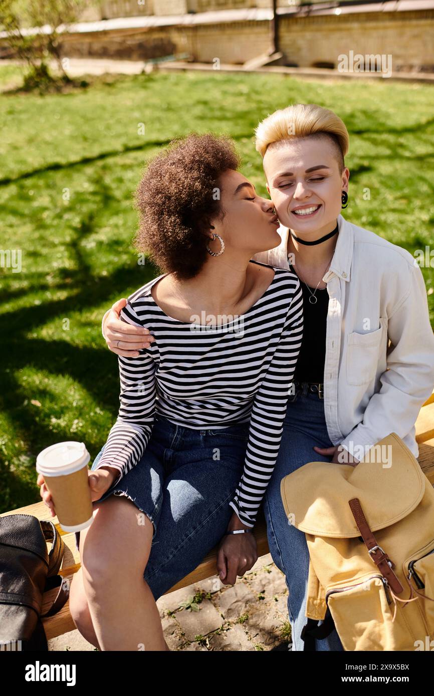 Two young girls share a loving kiss on a park bench, surrounded by the ...
