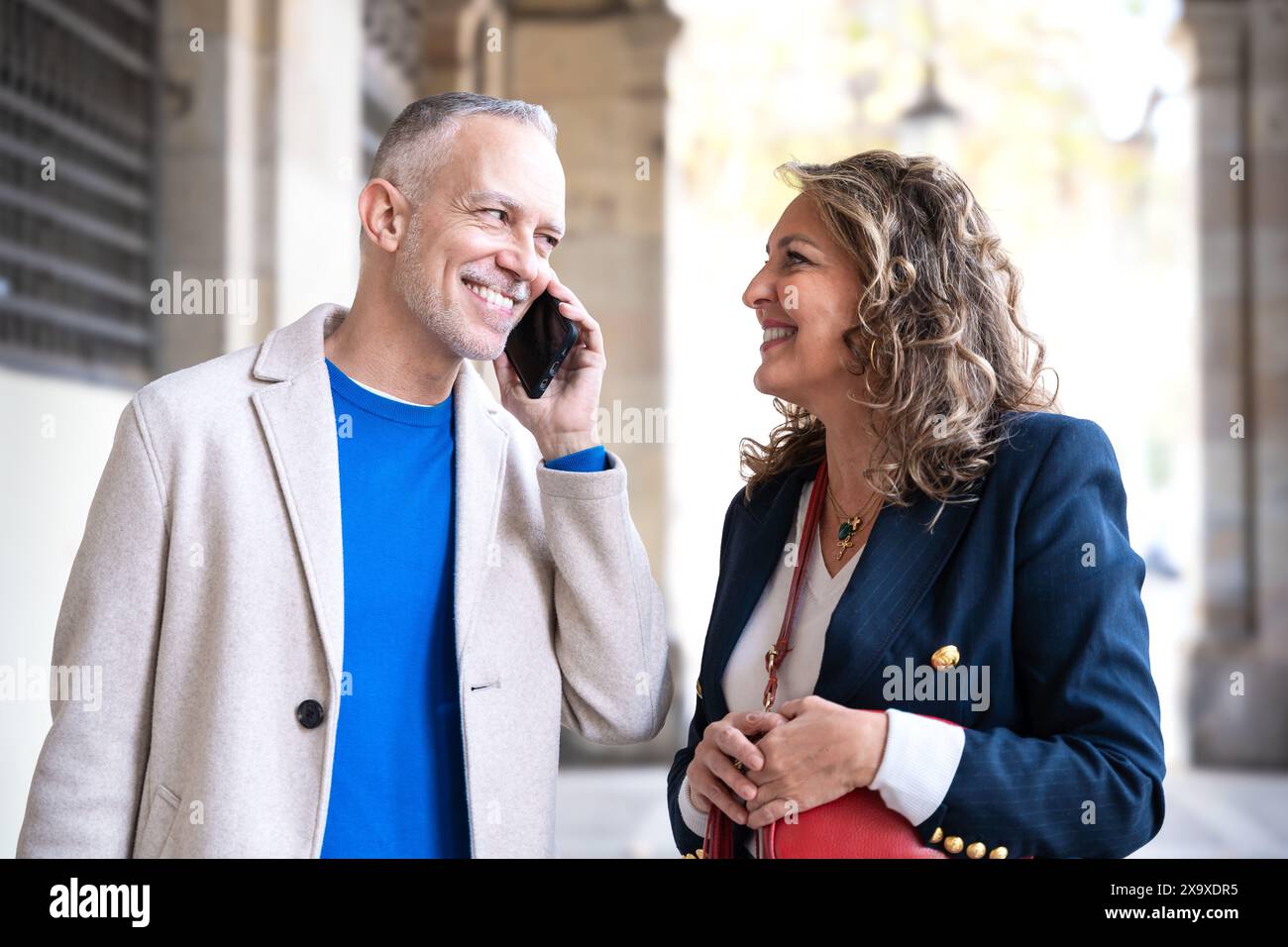 Happy friends or couples talking on smartphone outdoors. Stock Photo