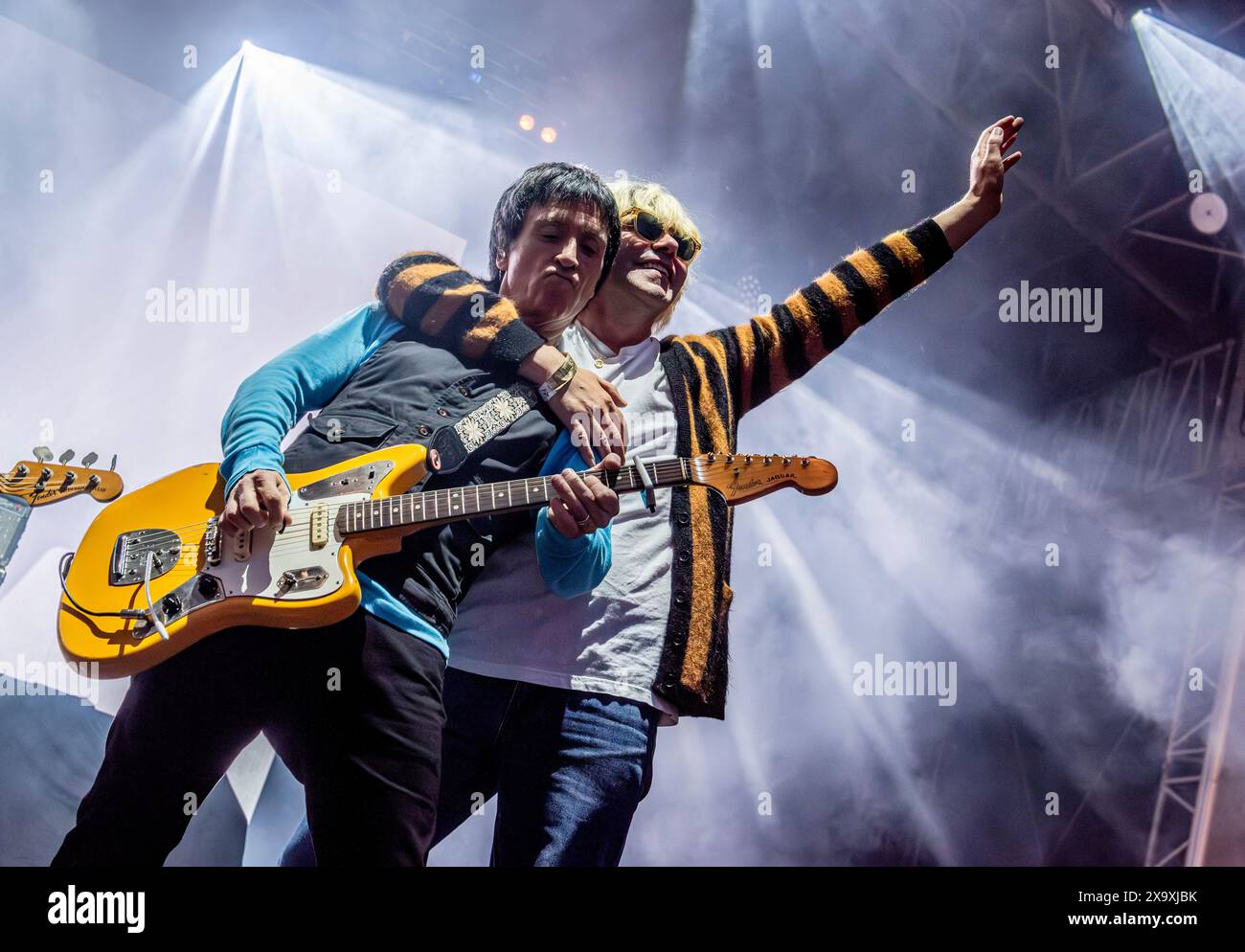 Former Smith's guitarist Johnny Marr and The Charlatans frontman Tim Burgess playing together at The Piece Hall in Halifax. Stock Photo