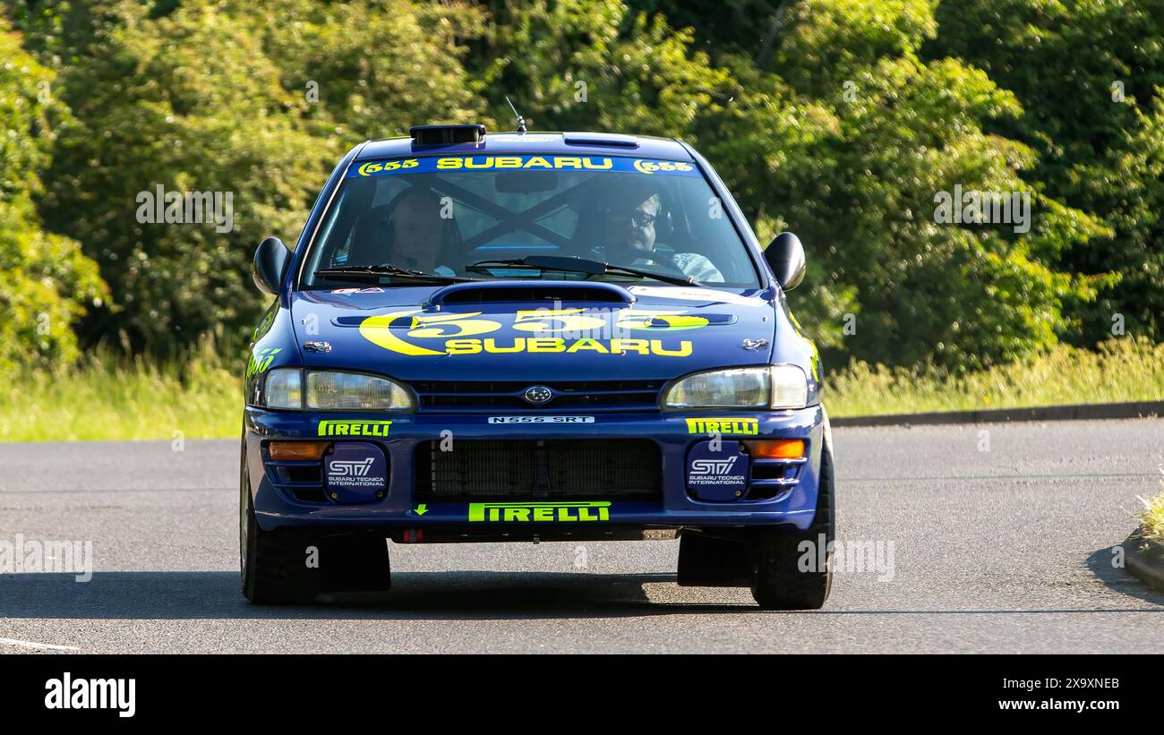 Stony Stratford,UK - June 2nd 2024: 1996 blue Subaru Impreza classic car driving on a British country road Stock Photo