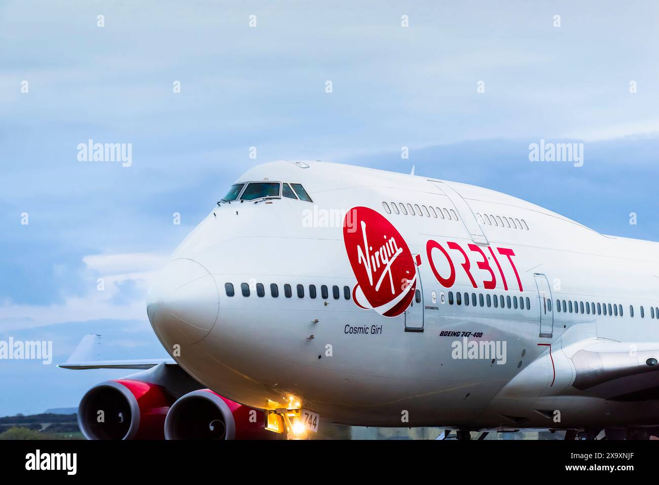 A close up view of the company logo and livery on the Virgin Orbit plane Cosmic Girl which is a 747-400 converted to a rocket launch platform taxiing to a halt on the runway at the Spaceport Cornwall in Newquay in Cornwall. Stock Photo