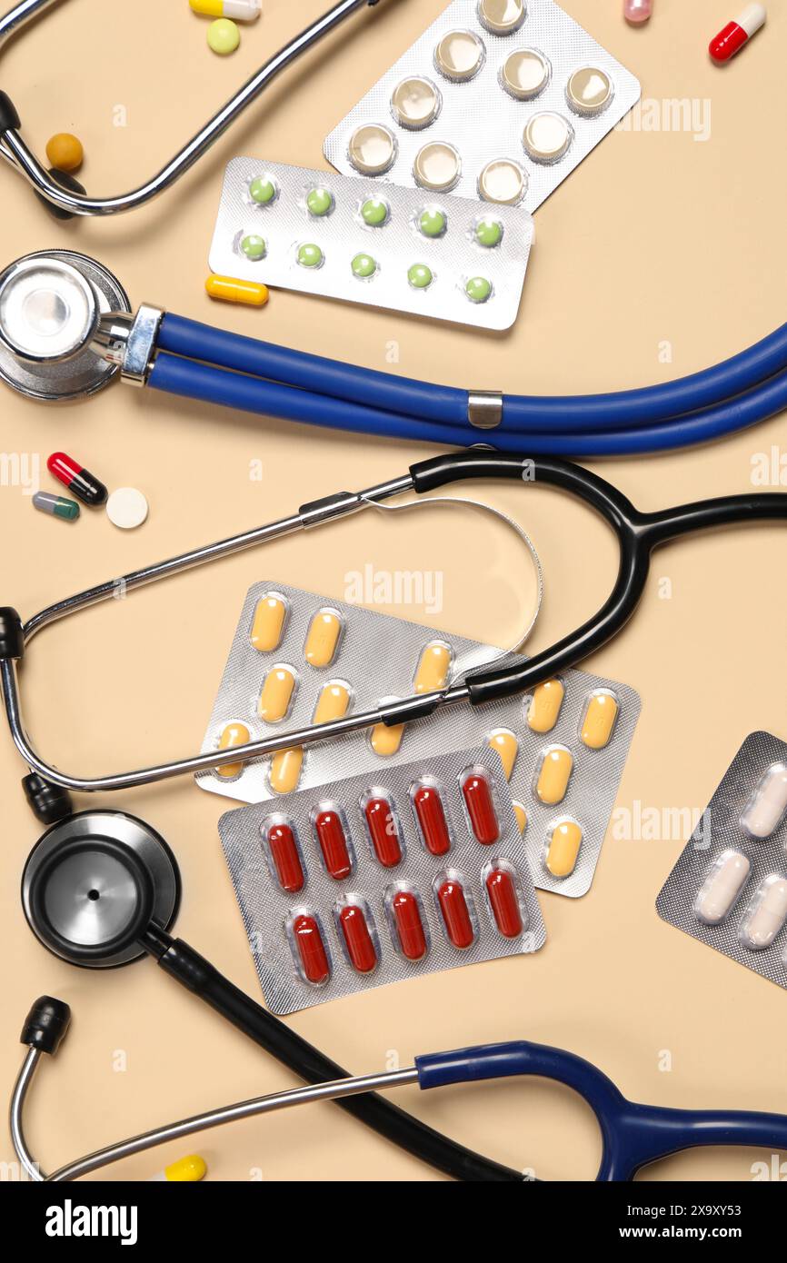 Stethoscope Tools Stethoscopes and pills on beige background, flat lay. Medical tools ...