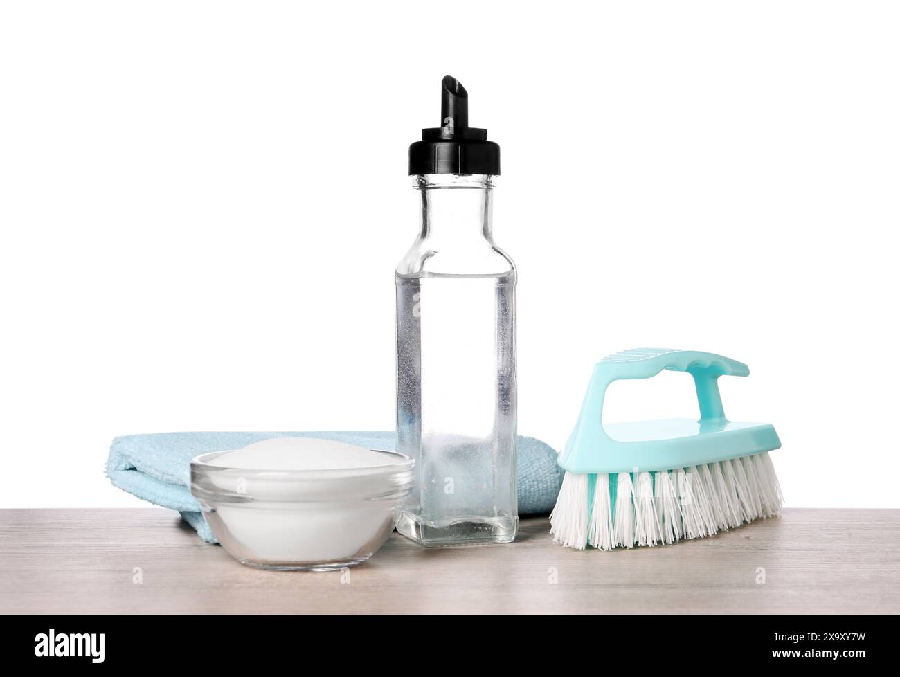 Natural cleaning products. Vinegar in bottle, baking soda, brush and ...