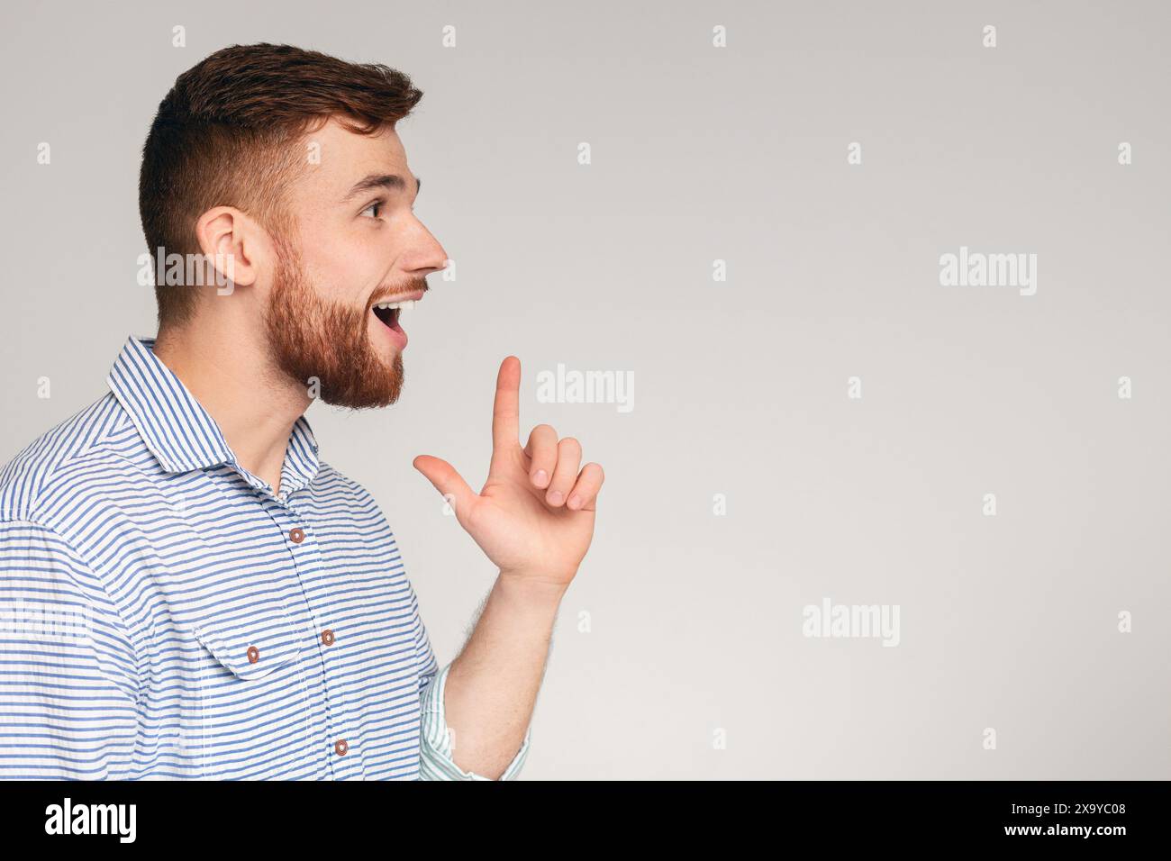 Young excited man having good idea and feeling happy Stock Photo