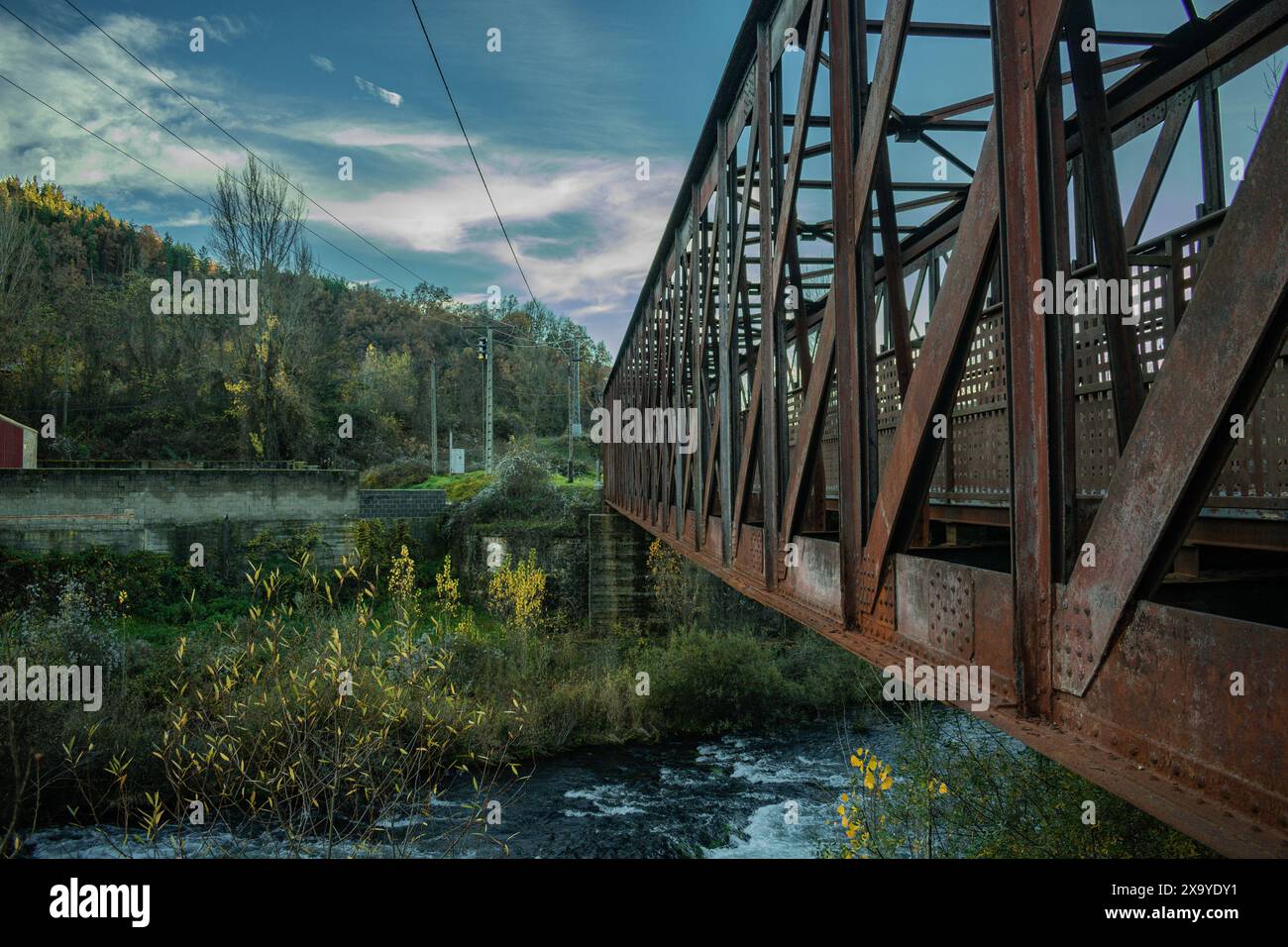 The Esla River flowing under Leonese town's iconic Iron Bridge Stock