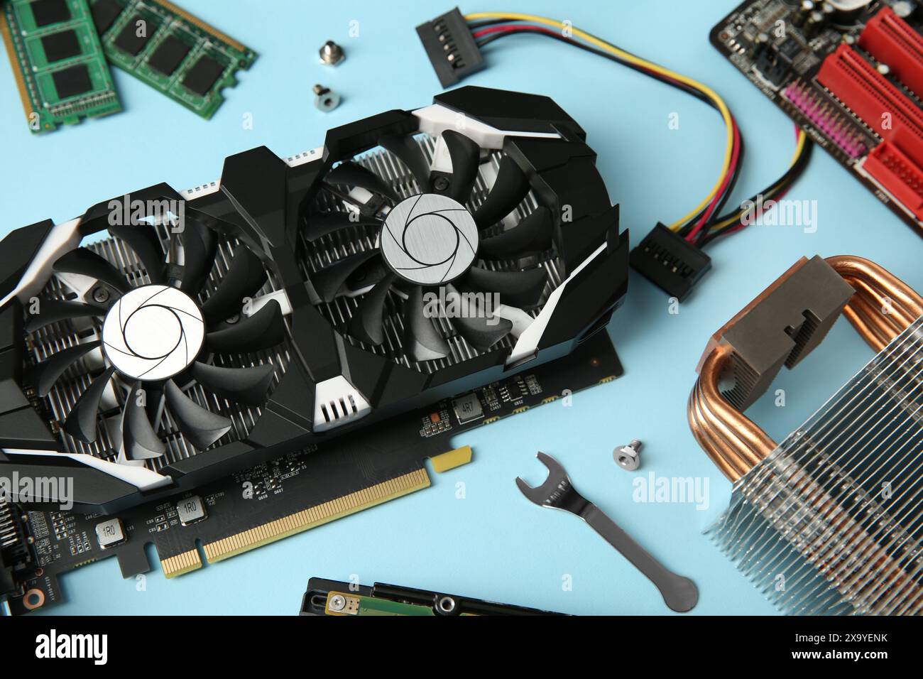 Graphics card and other computer hardware on light blue background ...