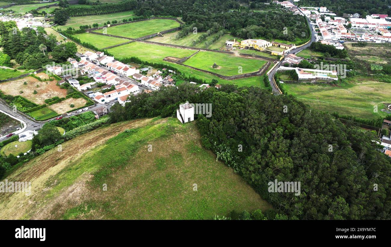 Aerial view of a village nestled among trees and hills Stock Photo - Alamy