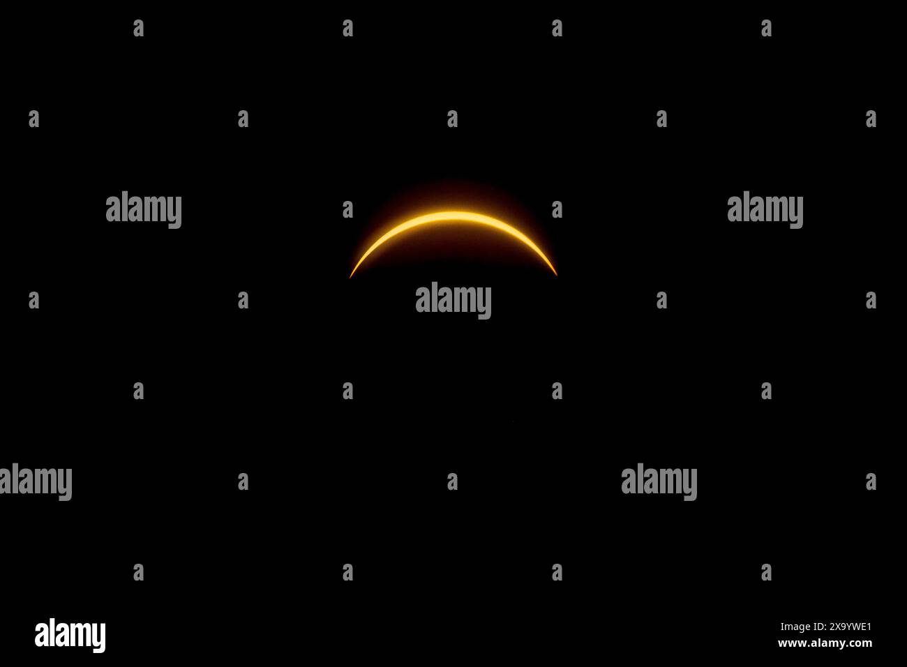 A solar eclipse featuring a diamond ring effect and baileys beads Stock Photo