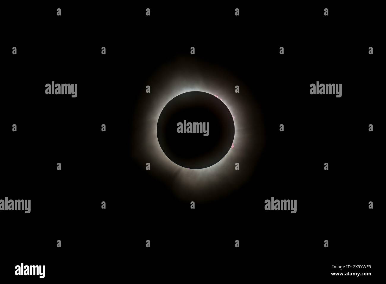 A solar eclipse featuring a diamond ring effect and baileys beads Stock Photo