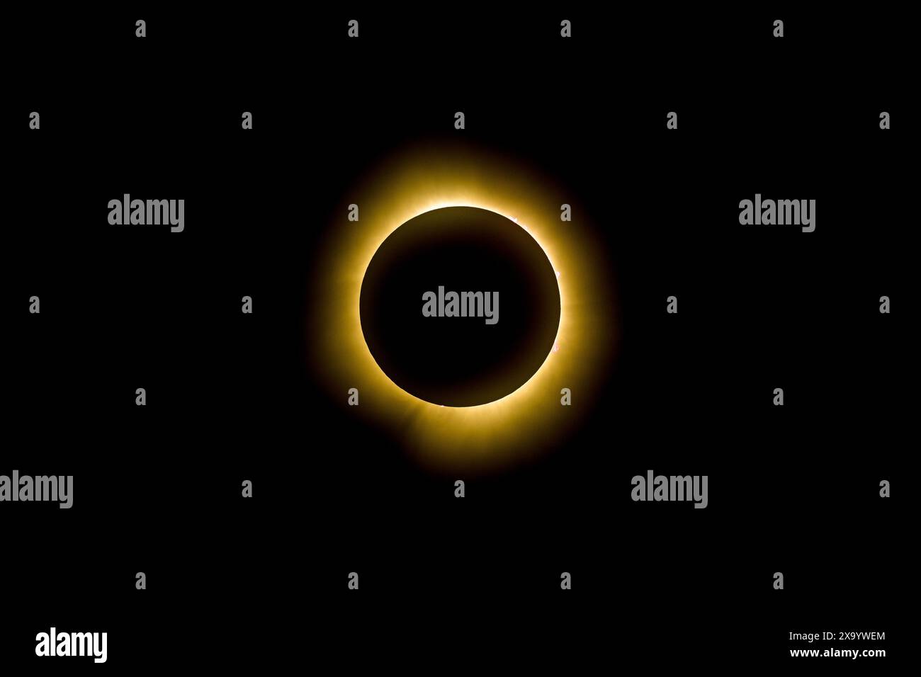 A solar eclipse featuring a diamond ring effect and baileys beads Stock Photo