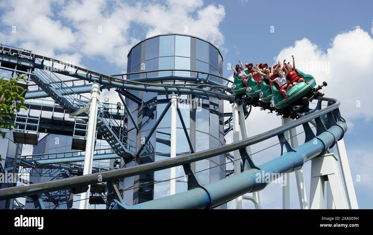Young people have fun on the Euro-Mir spinning roller coaster at 