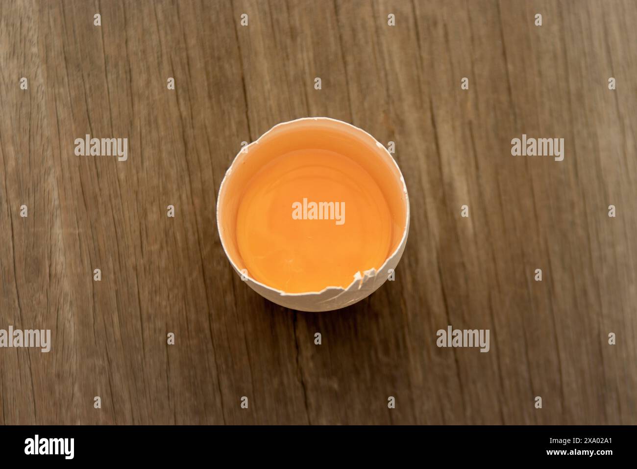 A top view of an egg on a wooden table surface Stock Photo