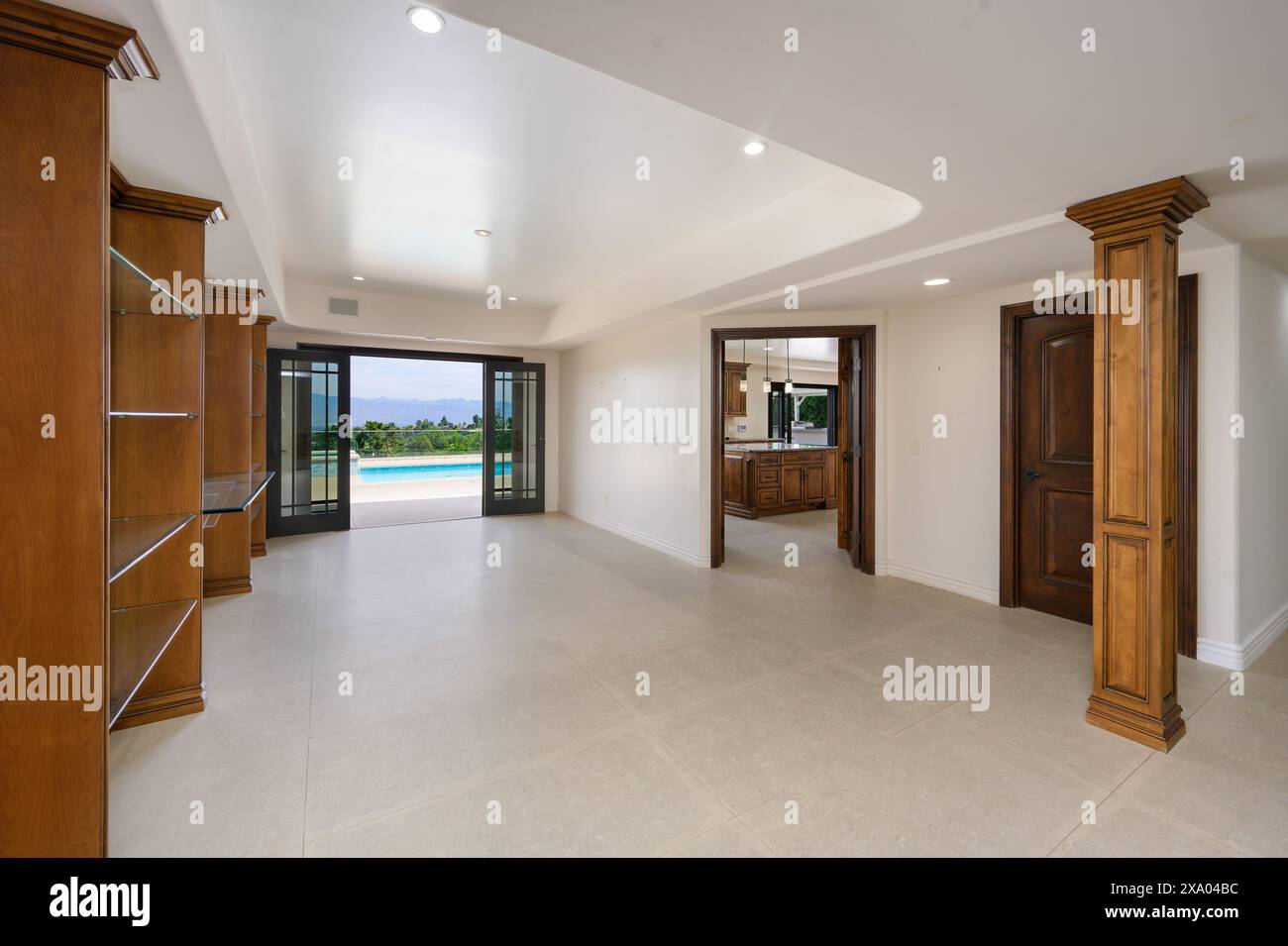 A swpacious entrance with wooden doors opening to indoor pool in a ...