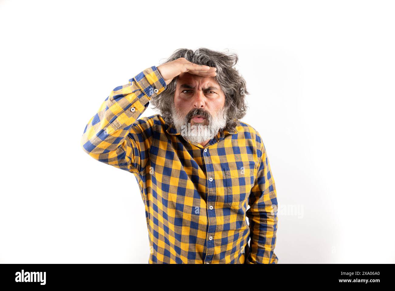 A middle-aged man with concerned look gazing into the distance in search of something Stock Photo