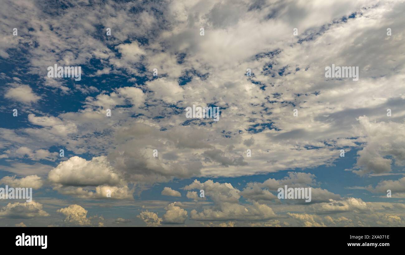 The bright blue sky with fluffy white clouds Stock Photo