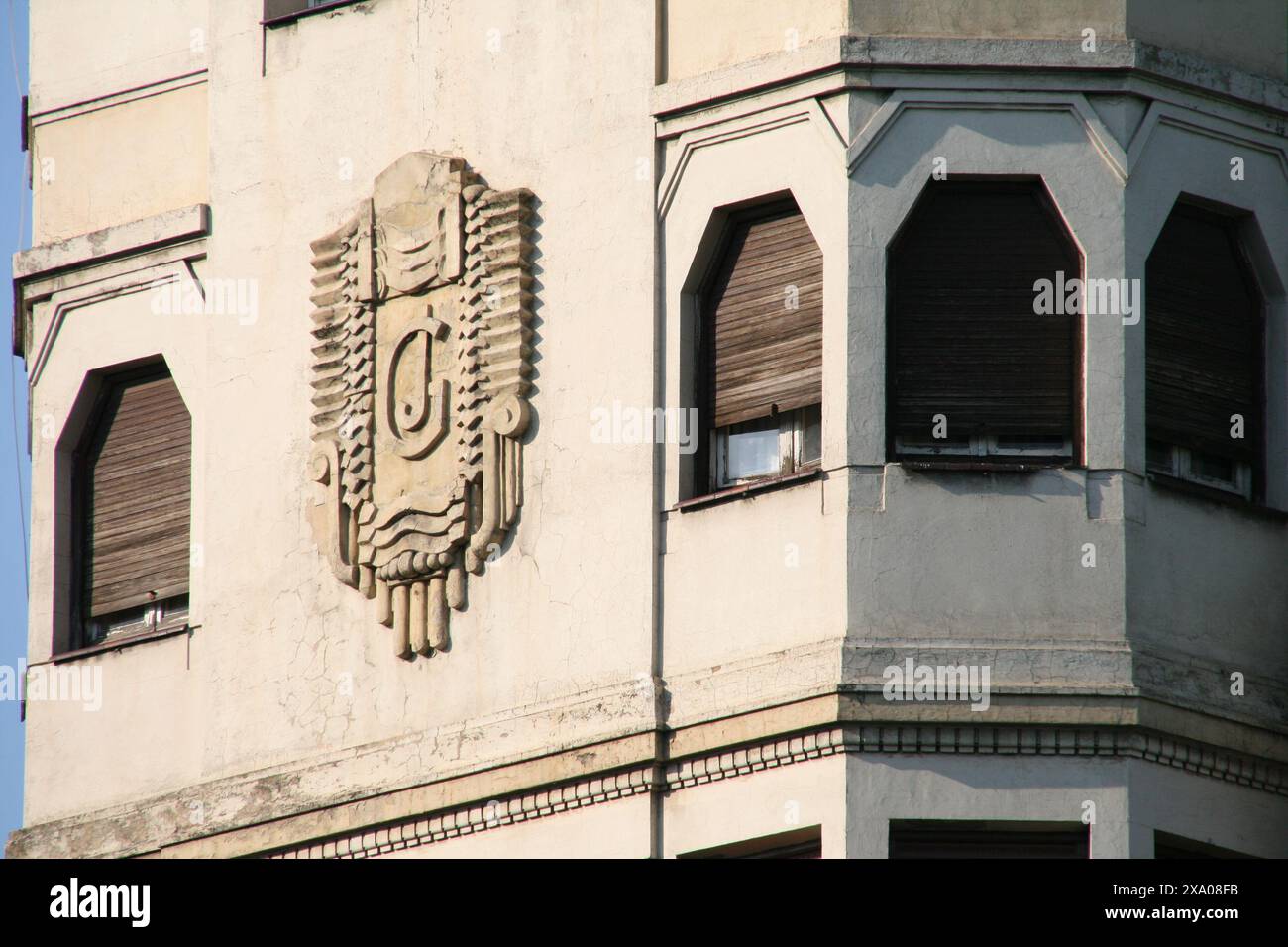 A tall, modern structure featuring a large, illuminated letter U on its ...