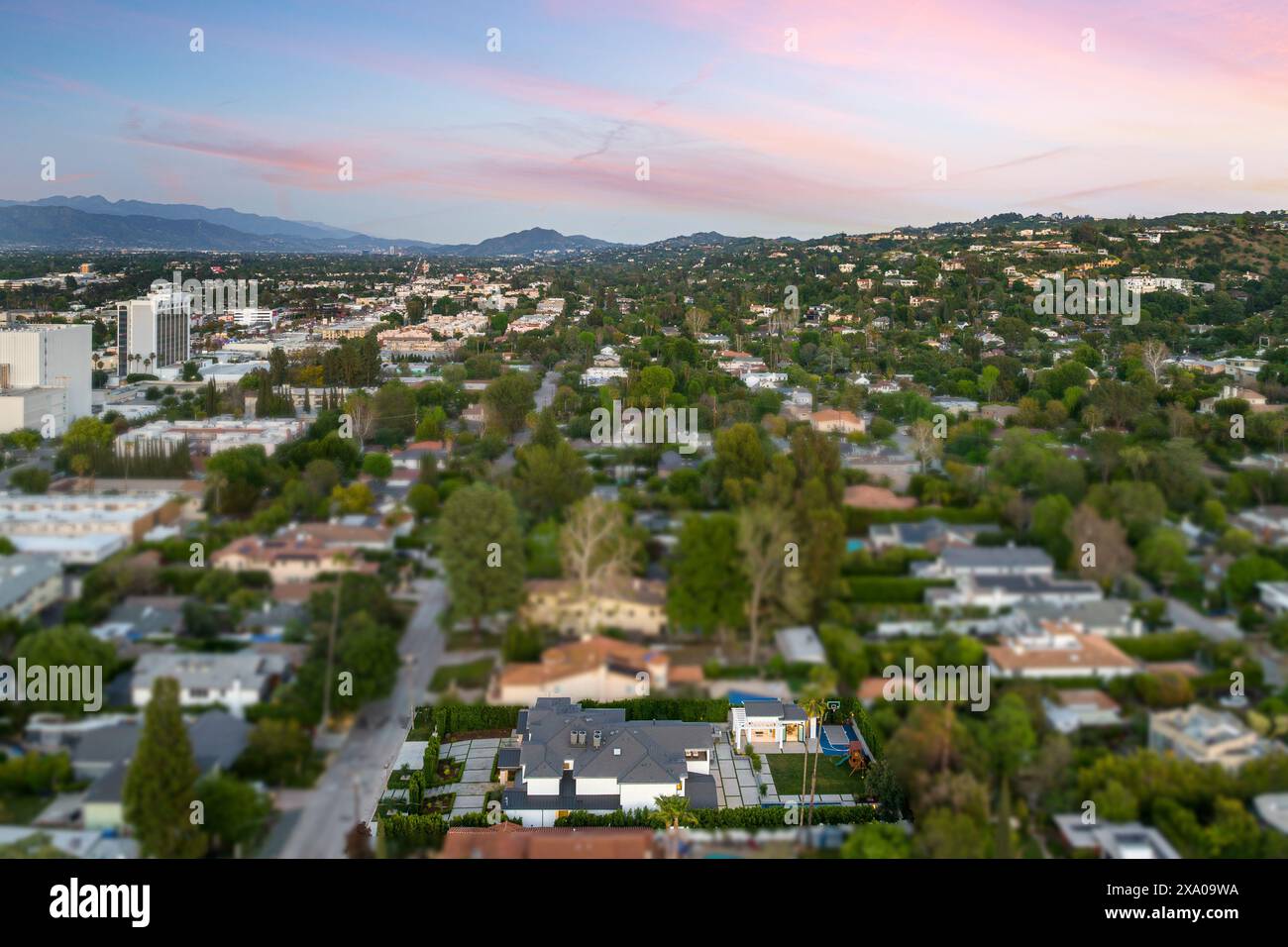 Aerial view of city with houses and lush green trees Stock Photo - Alamy