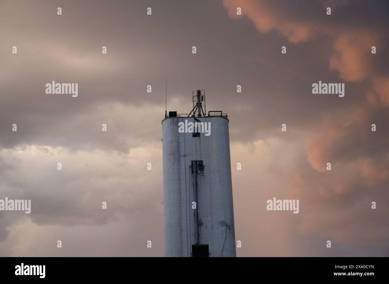 A tower silhouetted against a dramatic sunset sky Stock Photo - Alamy