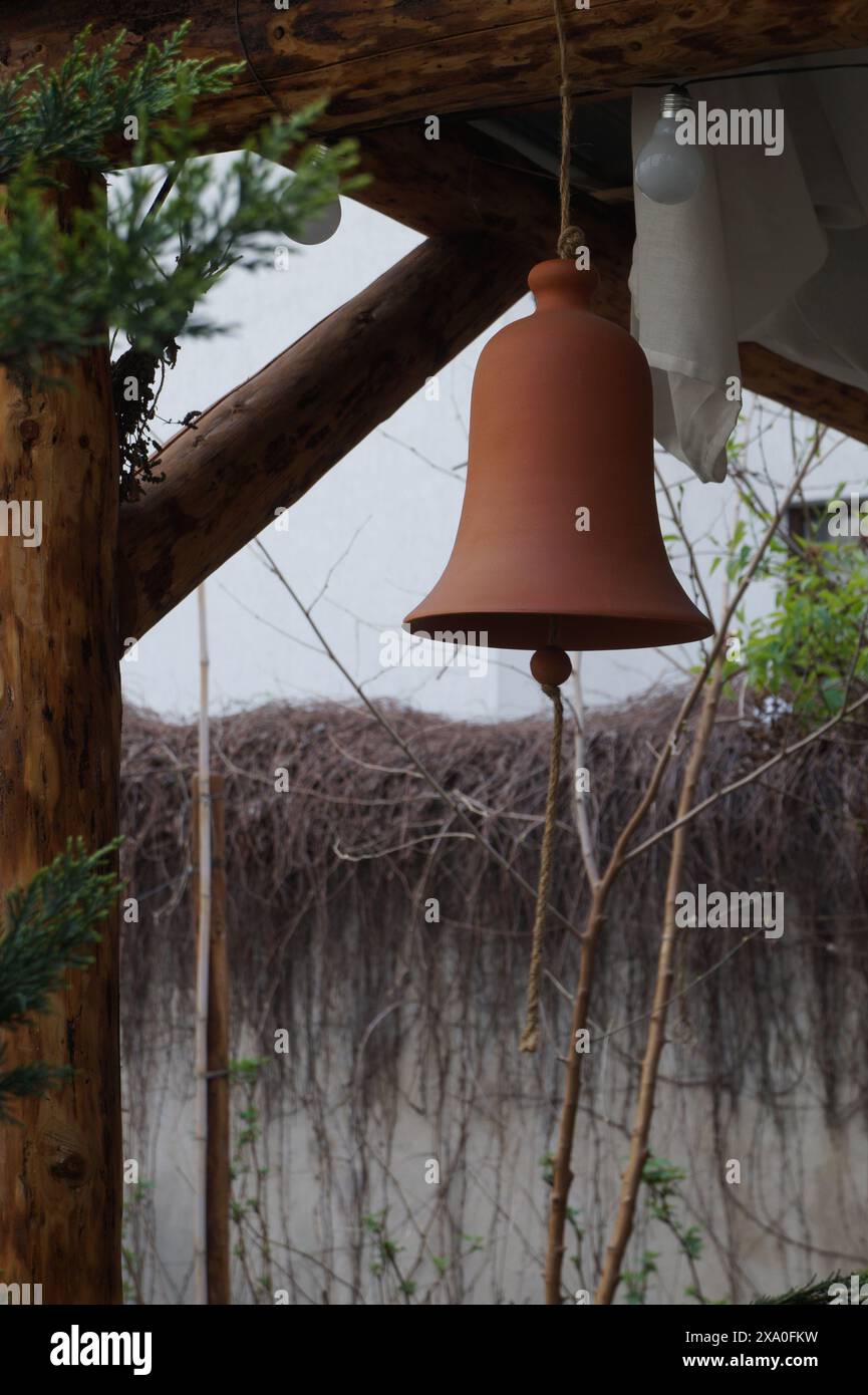 A ceramic bell, hanging from the roof Stock Photo