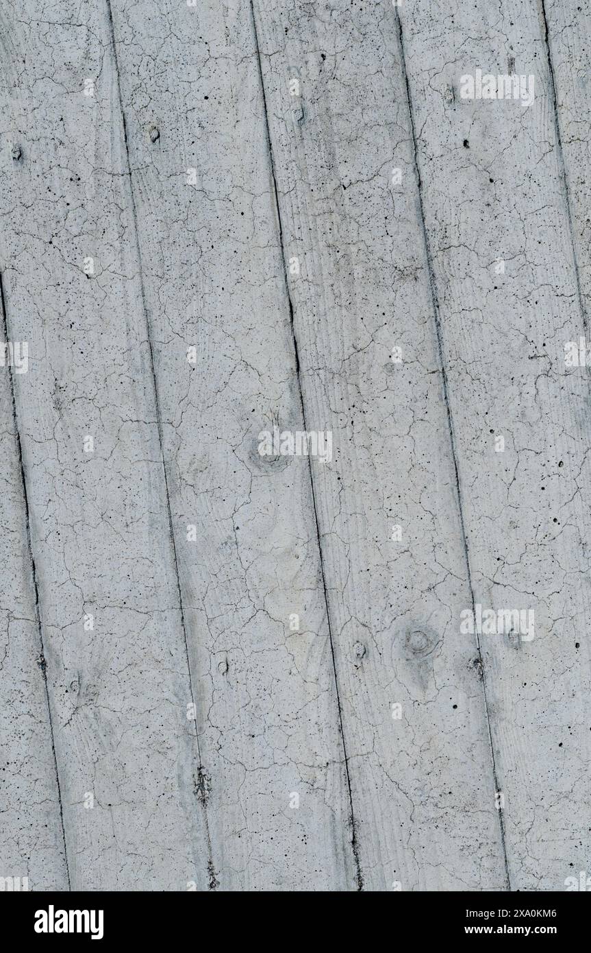 A pale gray concrete wall with small cracks Stock Photo