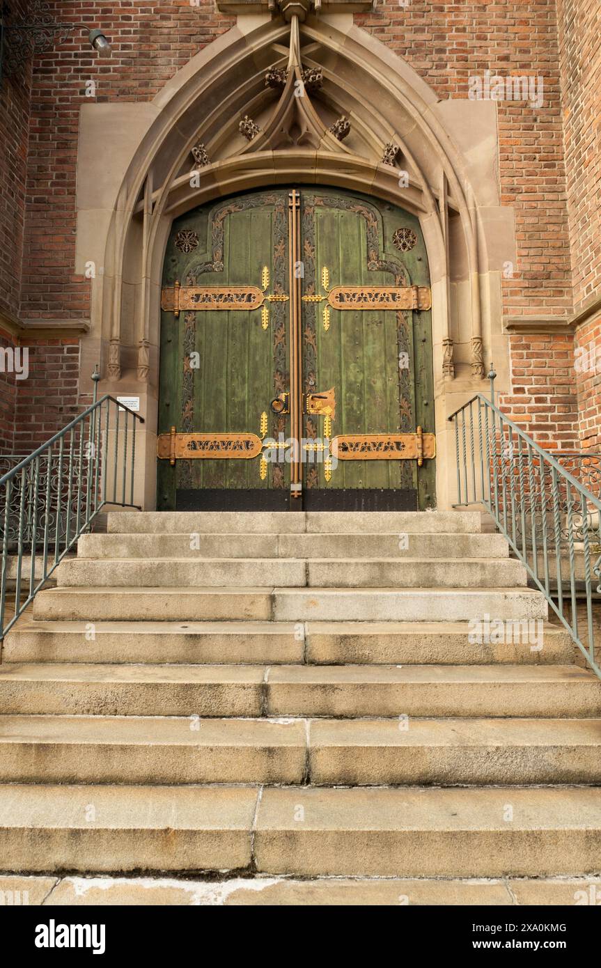 An ornate door of a church with stairs. Ulm, Germany Stock Photo