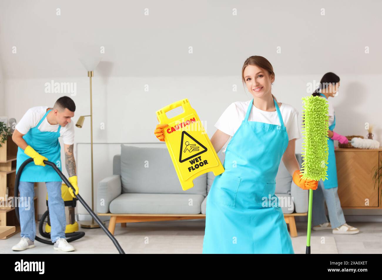 Female janitor caution sign hi-res stock photography and images - Alamy