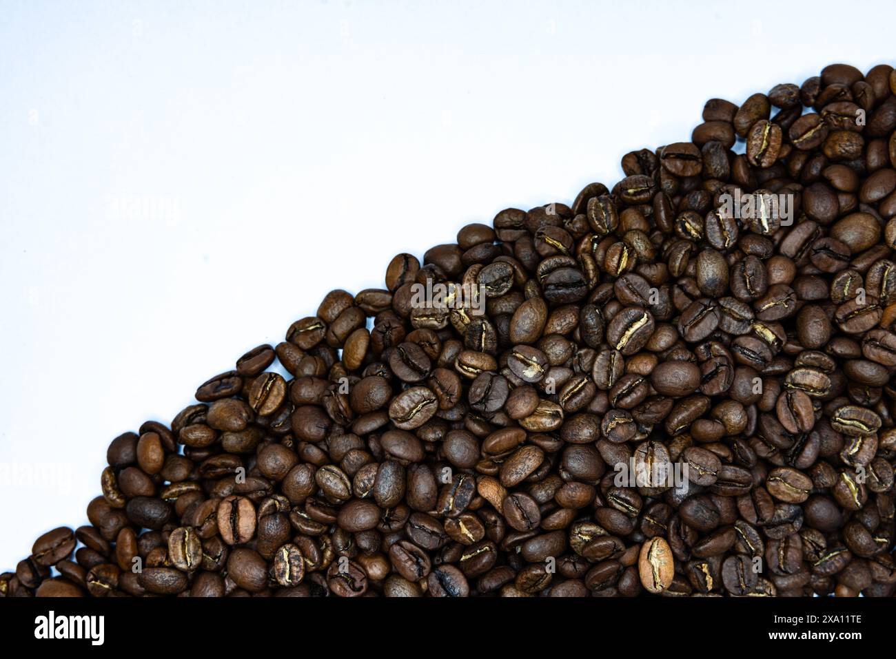 The coffee beans displayed on a plain white background. Stock Photo