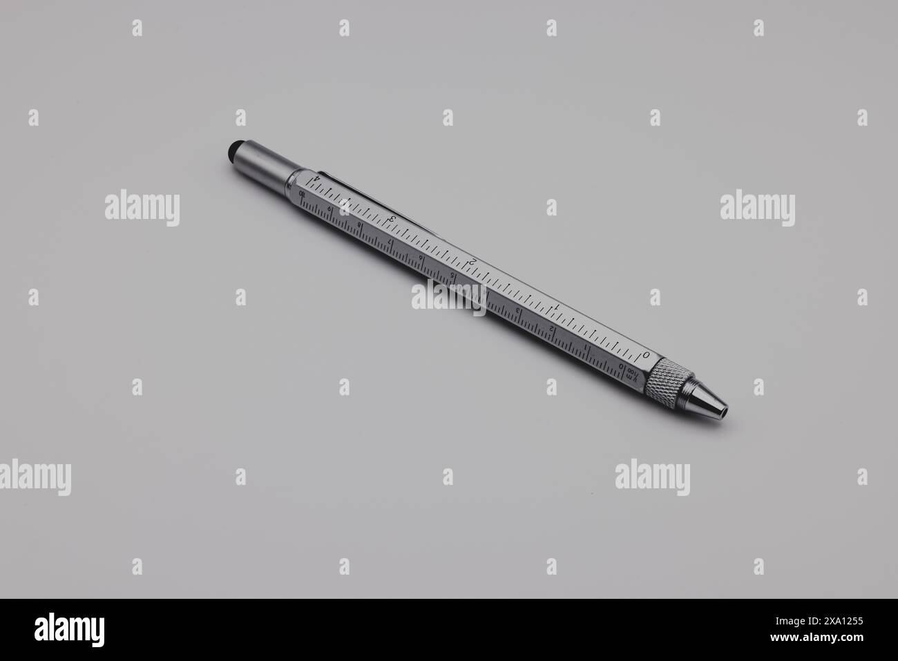 A pen rests on a gray table at an angle Stock Photo