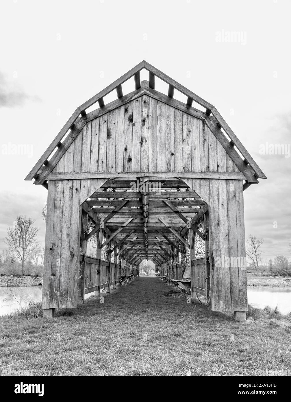 A monochrome image of a covered bridge Stock Photo