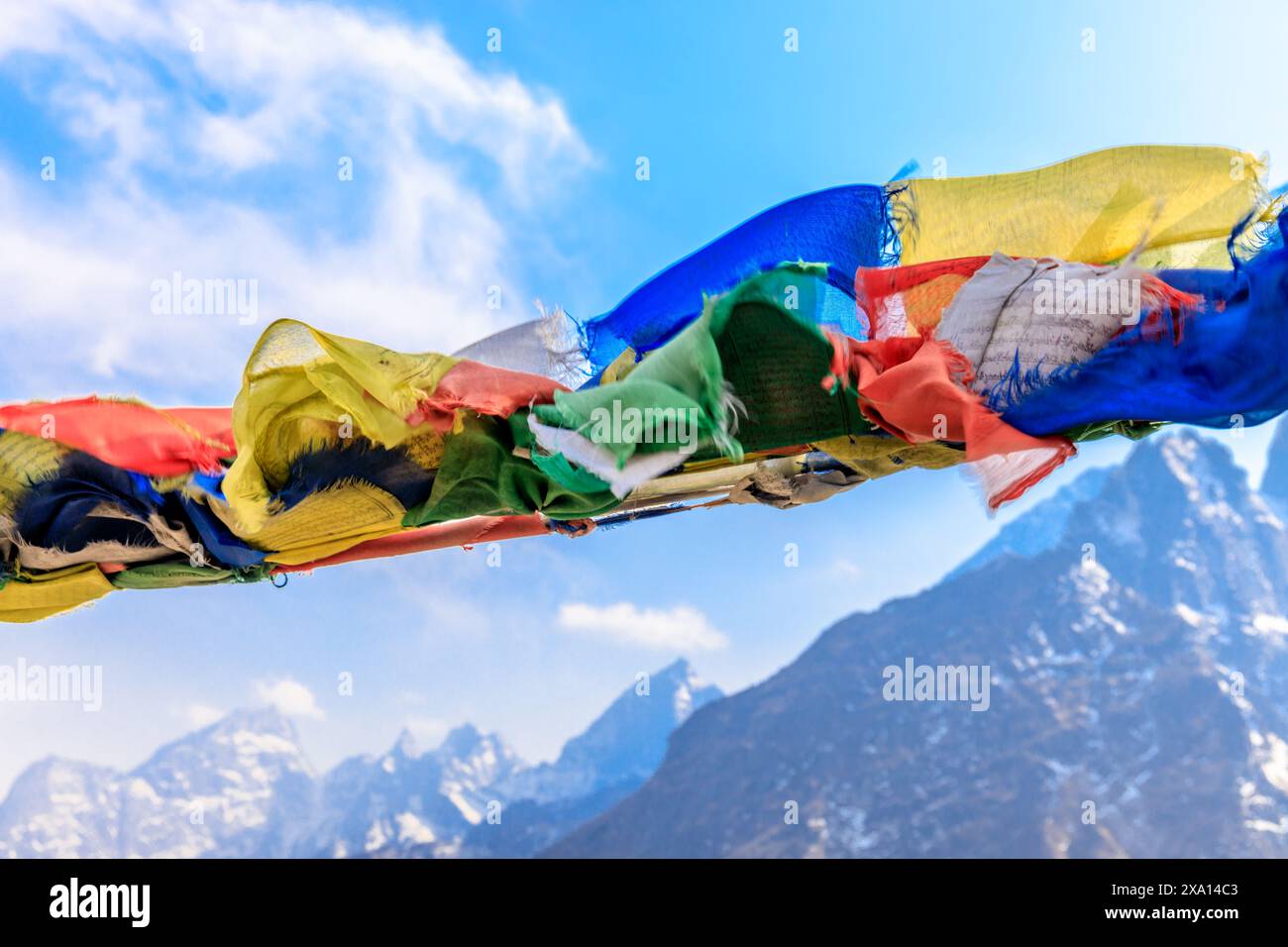 Colorful Nepali and Tibetan prayer flags fluttering in the majestic ...