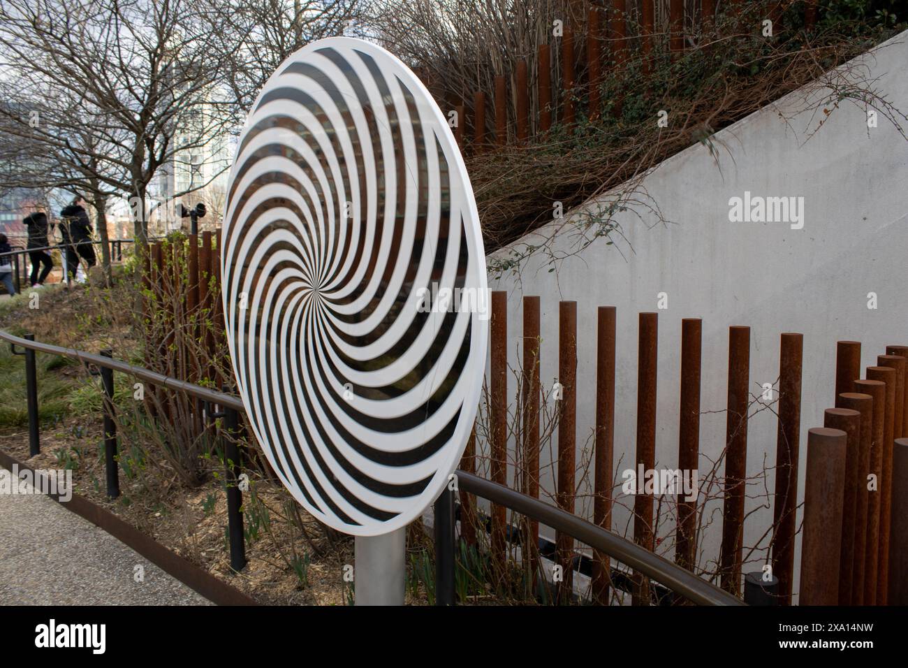 A painted sculpture on a street-side fence Stock Photo