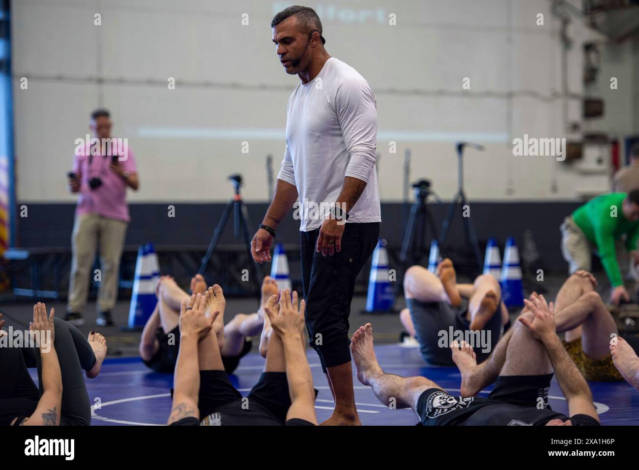 Philippine Sea, International Waters. 31 May, 2024. Vitor Belfort, Brazilian boxer and retired mixed martial arts fighter, leads sailors in a fitness session in the hangar bay aboard the U.S. Navy Nimitz-class aircraft carrier USS Ronald Reagan during a visit by the Finding Mastery team, May 31, 2024, in the Philippine Sea.  Credit: MCS Ryan Freiburghaus/US Navy/Alamy Live News Stock Photo