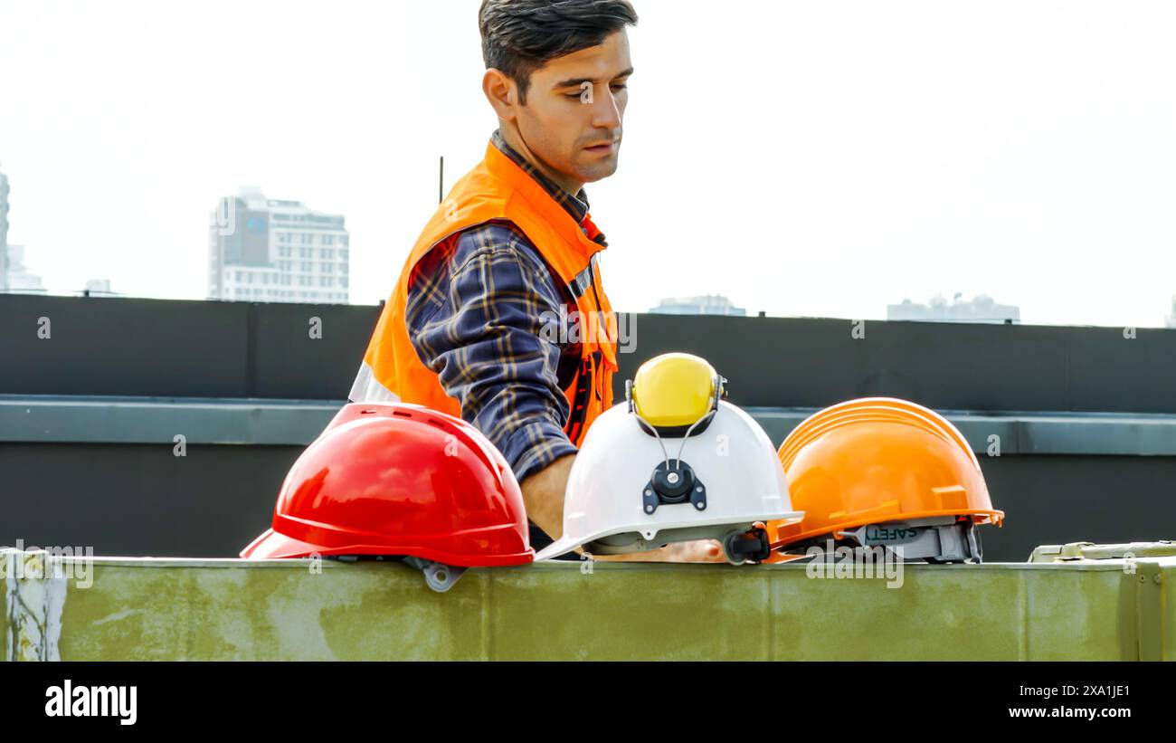 A man wearing a uniform, working at a construction site Stock Photo