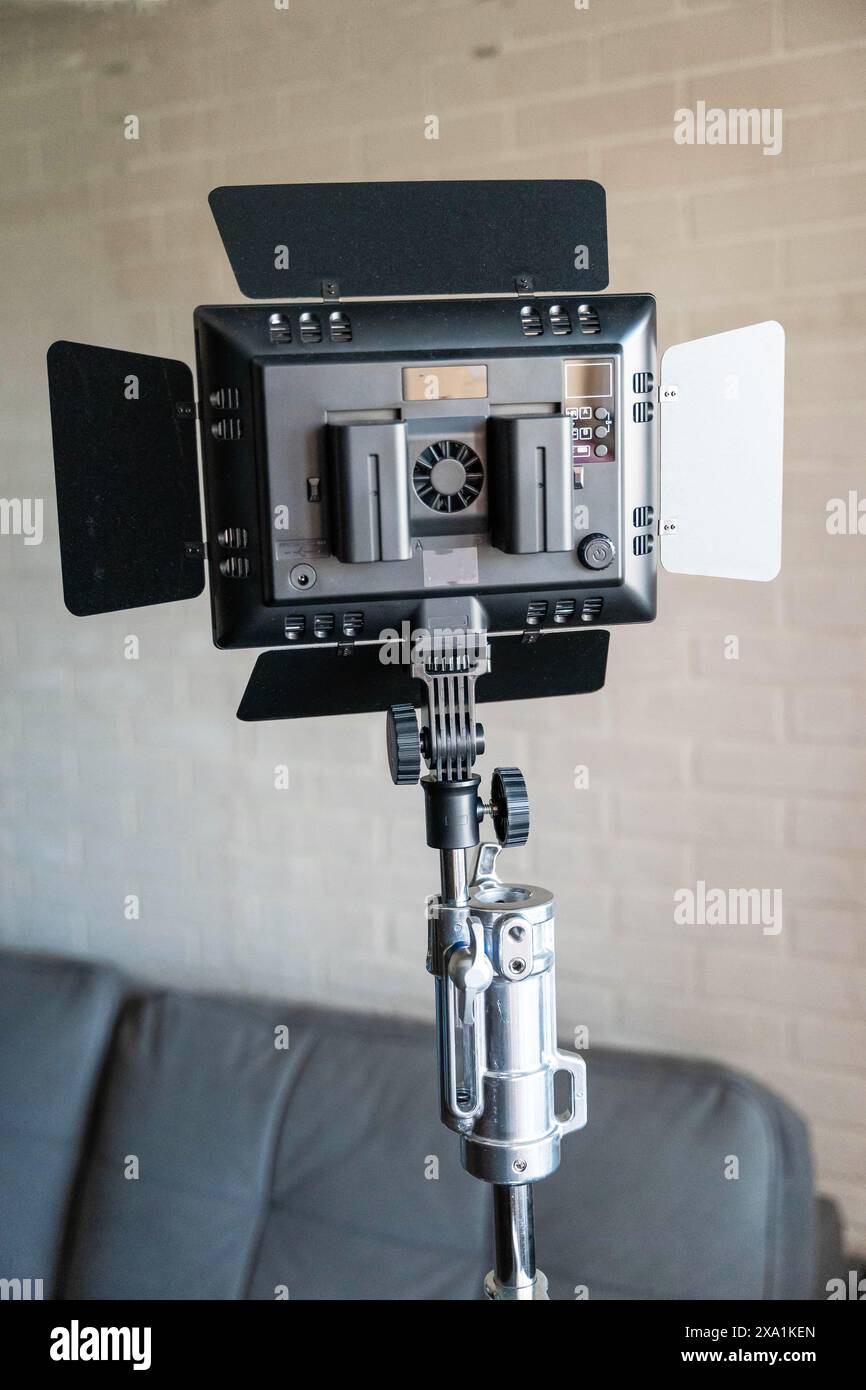 Rear view of a video lighting panel mounted on a tripod. LED flashlight ...